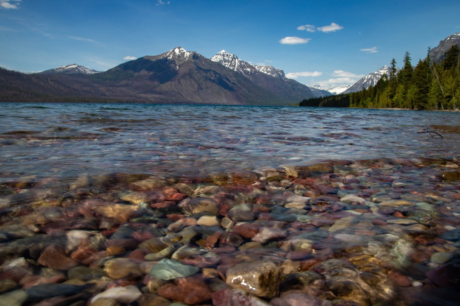 Clear mountain lake over colored stones