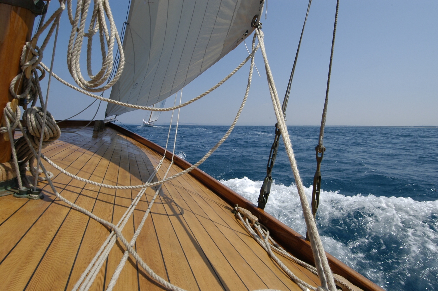 Looking forward along a wooden sailboat deck