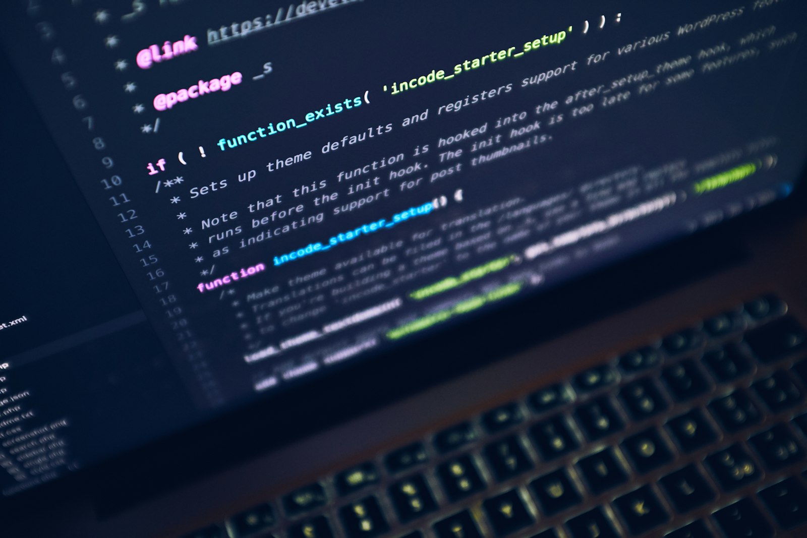 Application code on a laptop in a dark workspace